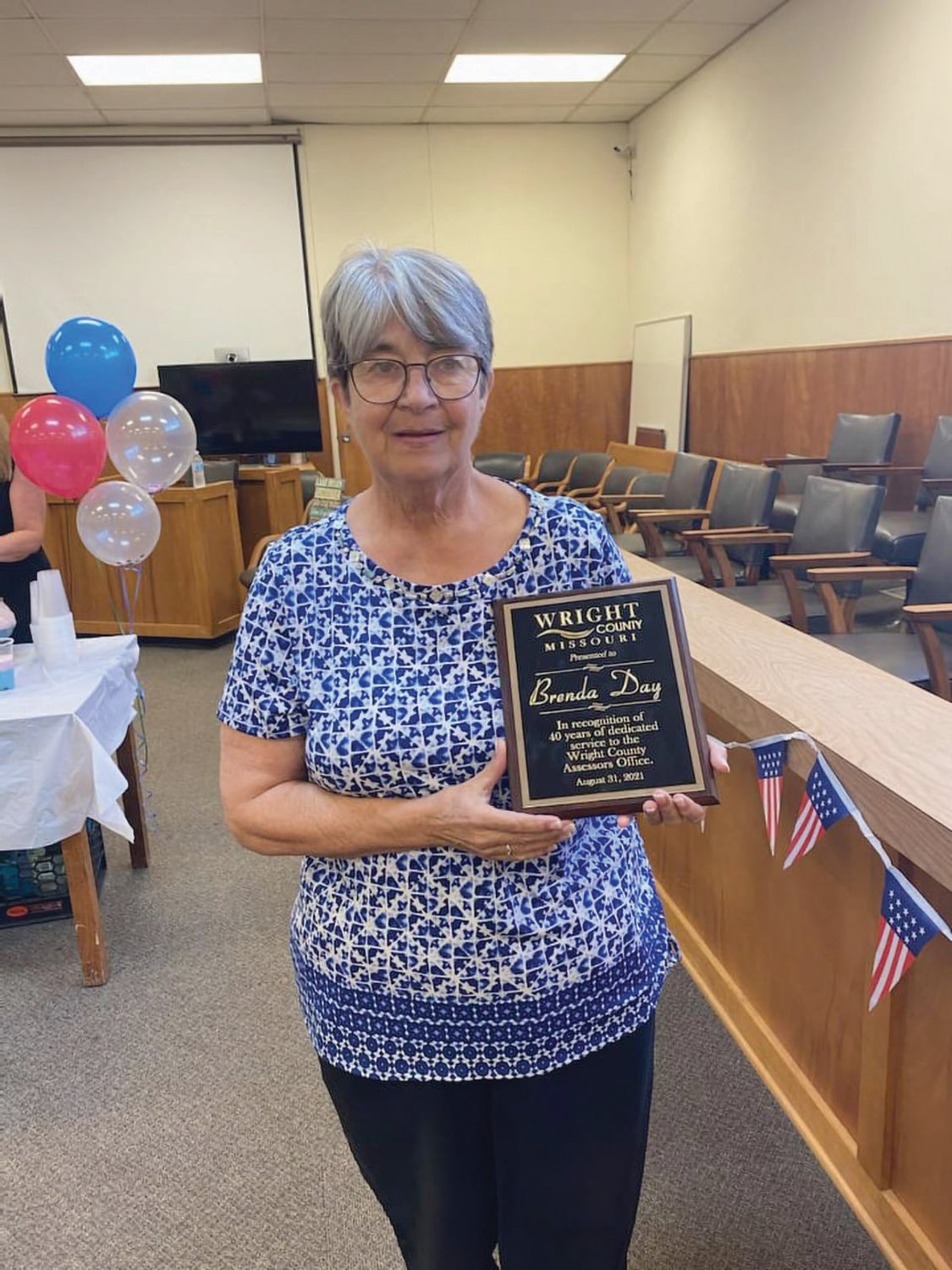 Brenda Day holds a plaque honoring her for 40 years of dedicated service to the Wright County Assessor’s Office at a retirement celebration at the end of August inside the Wright County Courthouse.